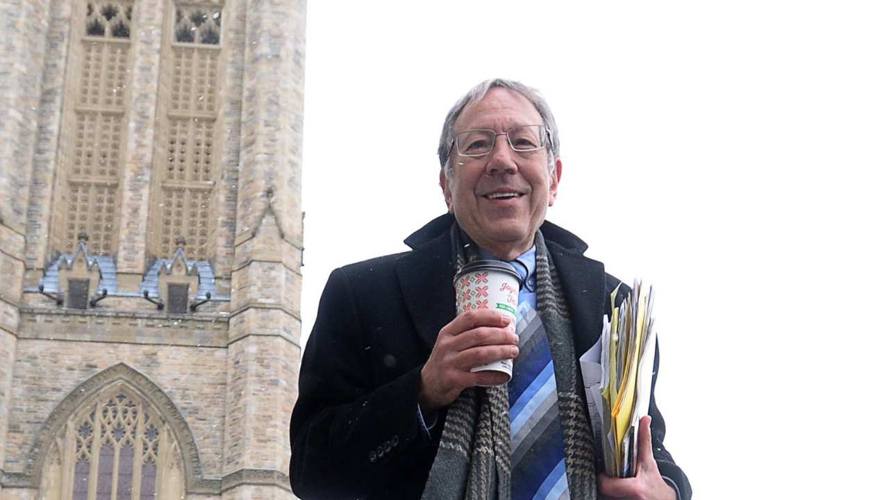 a man holding paperwork and a coffee